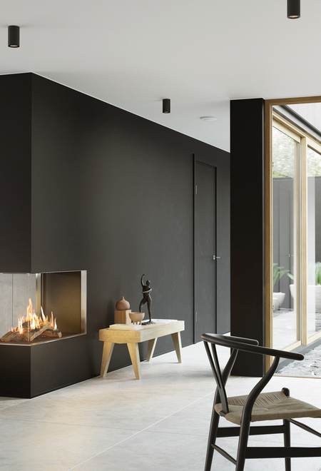 Gas-Kamin VISIO 90 RD passt als Raumteiler in einer schwarzen Wand ideal zwischen Wohnzimmer und Esszimmer und strukturiert den schlicht dekorierten Wohnraum