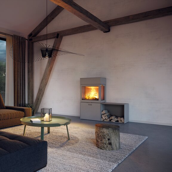 Holz-Kaminofen MAX 600/130 in Nickel mit zwei Seitenfenstern und Seitenbank in elegantem Wohnraum in Brauntönen