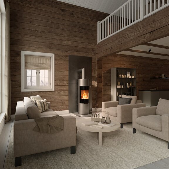 Holz-Kaminofen VIVA 140 L in der Farbe Platin mit Vollglas-Feuerraumtüre an Holzwand im rustikalen Wohnhaus